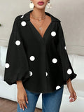 Polka dot, loose-fitting, puff-sleeved top with a semi-open collar.