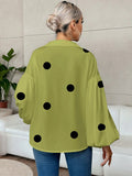 Polka dot, loose-fitting, puff-sleeved top with a semi-open collar.