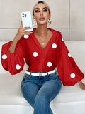 Polka dot, loose-fitting, puff-sleeved top with a semi-open collar.