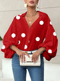 Polka dot, loose-fitting, puff-sleeved top with a semi-open collar.