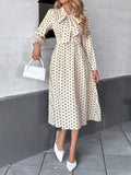 Elegant mid-length skirt with bow tie collar, long sleeves and waist polka dot dress